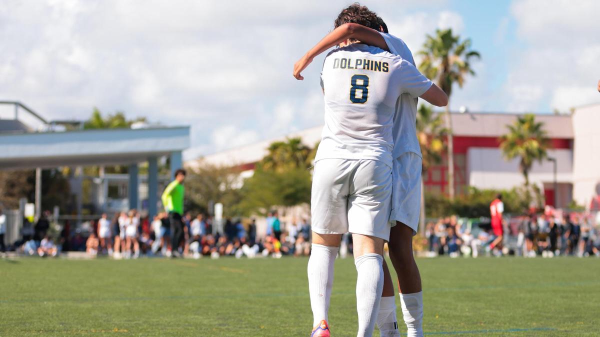Downtown Doral forward Santiago Ramos (8) celebrates with Alejandro Avila (18) after scoring against the MAST Academy during the second half of a boys soccer Region 4-3A quarterfinal playoff game at MAST Academy in Miami, Florida, Tuesday, February 11, 2025.