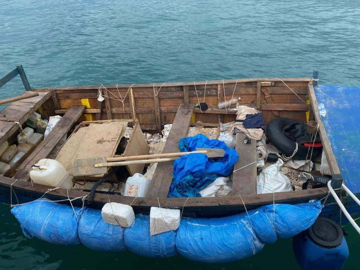 A makeshift wooden boat floats off Boot Key Harbor in the Florida Keys on Wednesday, Sept. 22, 2021. The Coast Guard said 16 people from Cuba trying to migrate to the United States were on board the vessel.