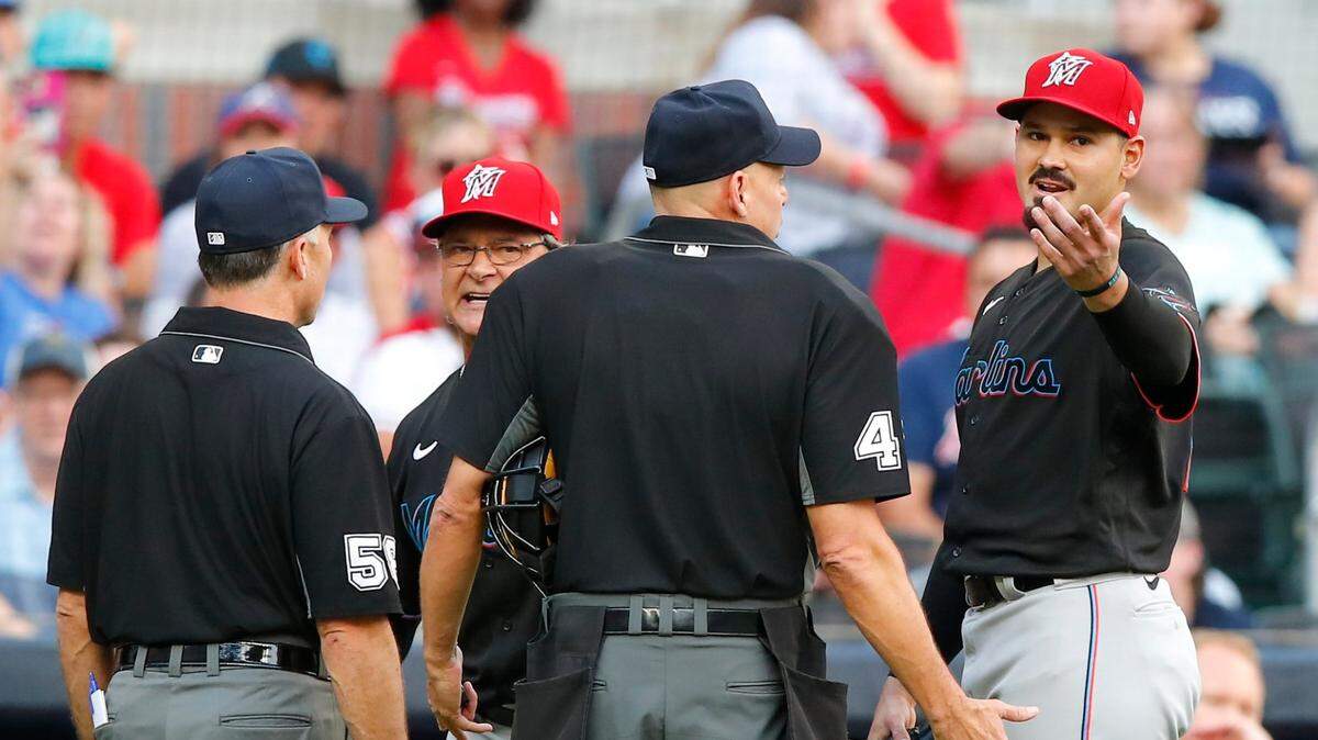 Manager Don Mattingly and Pablo Lopez #49 of the Miami Marlins argue with umpires after both are ejected in the first inning of their MLB game against the Atlanta Braves at Truist Park on July 2, 2021 in Atlanta, Georgia.
