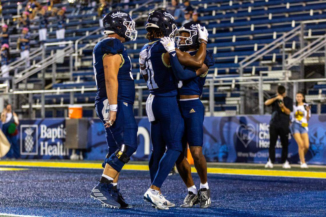 Florida International University Panthers wide receiver Eric Rivers (3) celebrates with teammates Dean Patterson (11) and lineman Jaheim Buchanon (59) after scoring a touchdown during the second half of an NCAA Conference USA football game against the New Mexico State Aggies at Pitbull Stadium on Tuesday, October 29, 2024, in Miami, Fla.