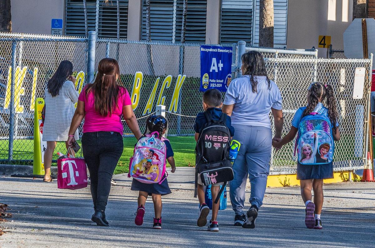 Parents bring their children to Biscayne Beach Elementary School for the first day of school in Miami-Dade schools in Miami Beach, on August 15, 2024.