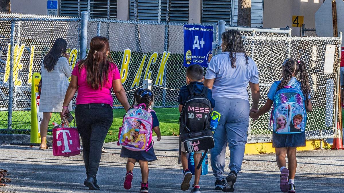 Parents bring their children to Biscayne Beach Elementary School for the first day of school in Miami-Dade schools in Miami Beach, on August 15, 2024.