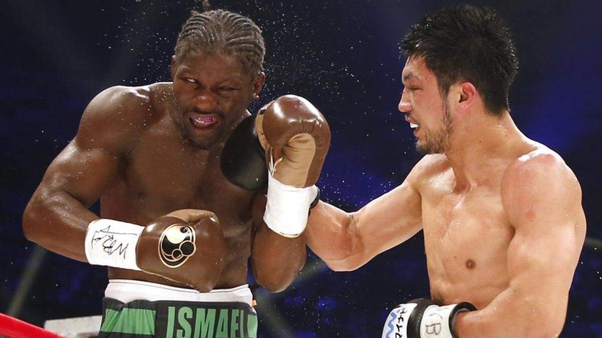 French champion Hassan N’Dam N’Jikam, left, gets a right from Japanese challenger Ryota Murata in the 12th round of their WBA middleweight boxing world title match in Tokyo, Saturday, May 20, 2017. N’Dam defended his title by a 2-1 decision.
