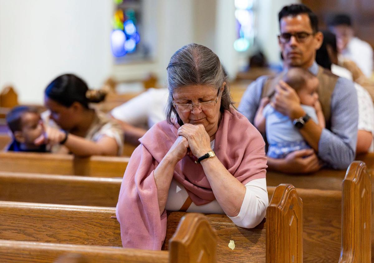 Amalia Cordido, 73, prays during a Good Friday service at the Cathedral of St. Mary on Friday, April 18, 2025, in Miami, Fla.