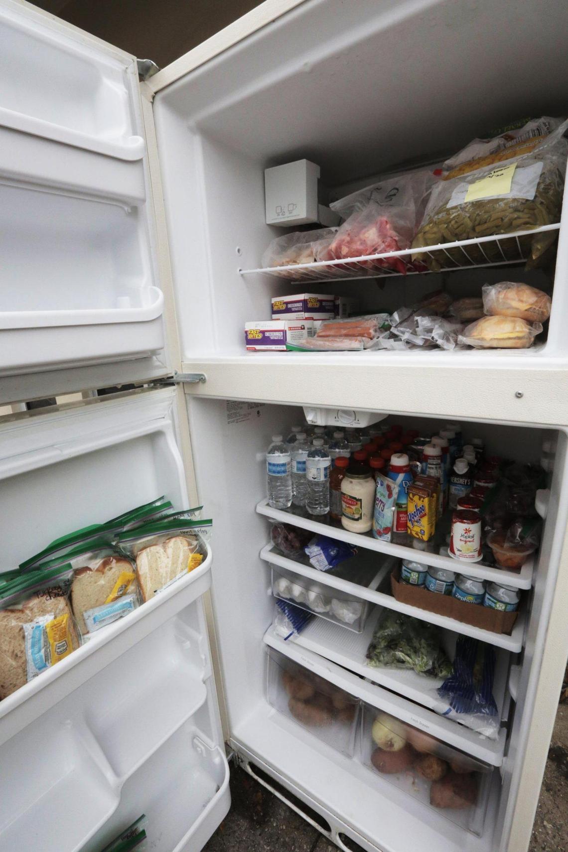 A fully stocked community refrigerator in front of the Roots Collective.