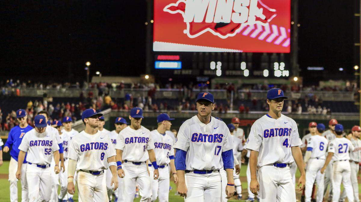 Florida players return to the dugout following an NCAA College World Series baseball game against Arkansas in Omaha, Neb., Friday, June 22, 2018.