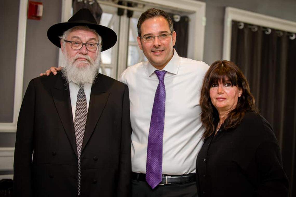 Dovy Ainsworth, center, with his parents, Tzvi Ainsworth, left, and Ingrid ‘Itty’ Ainsworth, who had moved from Australia to be closer to their children.
