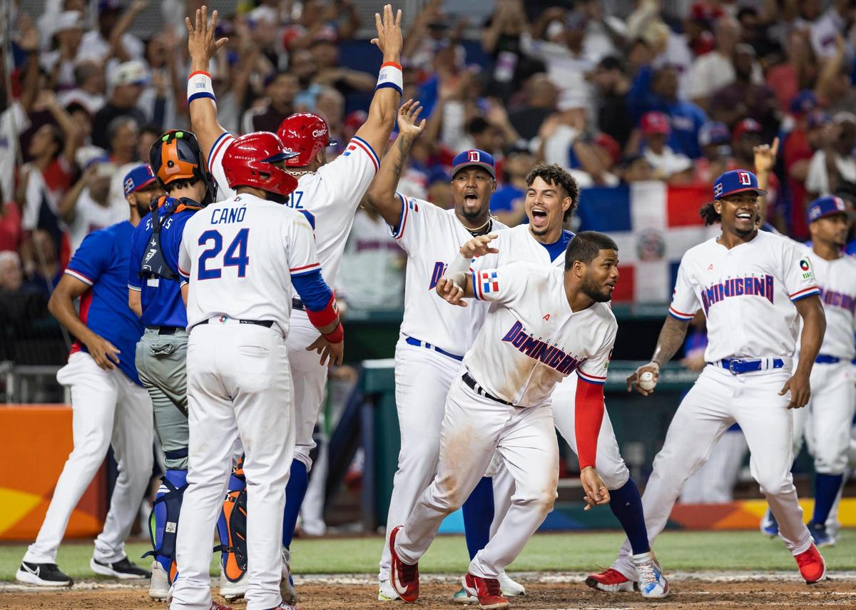 Dominican Republic infielders Nelson Cruz (23) and Robinson Cano (24) celebrate after scoring runs against Israel to win the game during the seventh inning of a Pool D game at the World Baseball Classic at loanDepot Park on Tuesday, March 14, 2023, in Miami, Fla.
