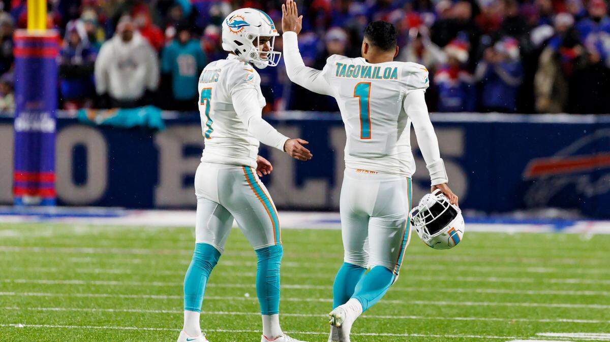 Miami Dolphins place kicker Jason Sanders (7) celebrates with teammate Tua Tagovailoa (1) after kicking a field goal during fourth quarter of an NFL football game against the Buffalo Bills at Highmark Stadium on Saturday, December 17, 2022 in Orchard Park, New York.