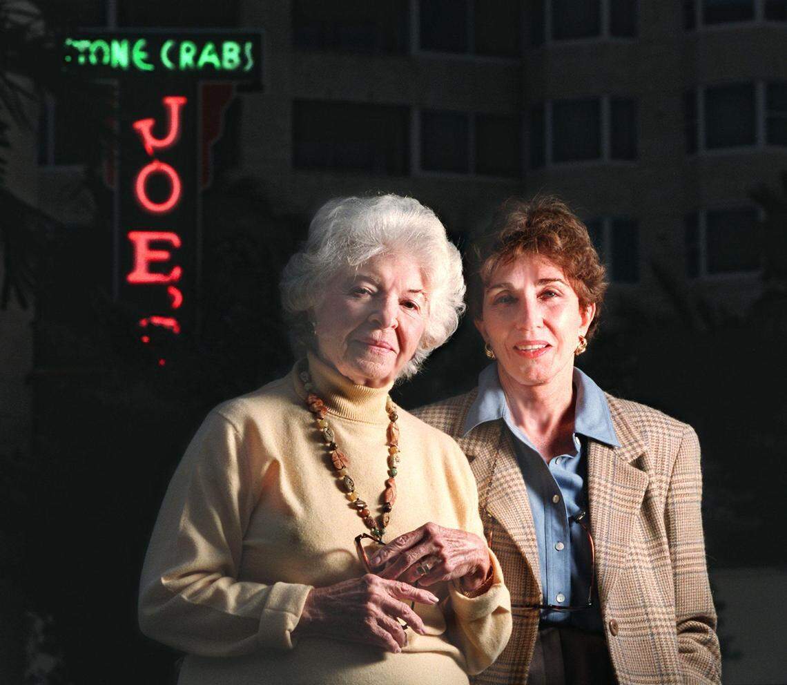In this file photo from Dec. 8, 1997, Joe’s Stone Crabs’ then-owners Grace Weiss, the stepmother who raised Jo Ann Weiss Sawitz Bass as her own after Jo Ann’s birth mother died when she was 16 months old, stands with Jo Ann, outside of the landmark Miami Beach restaurant.