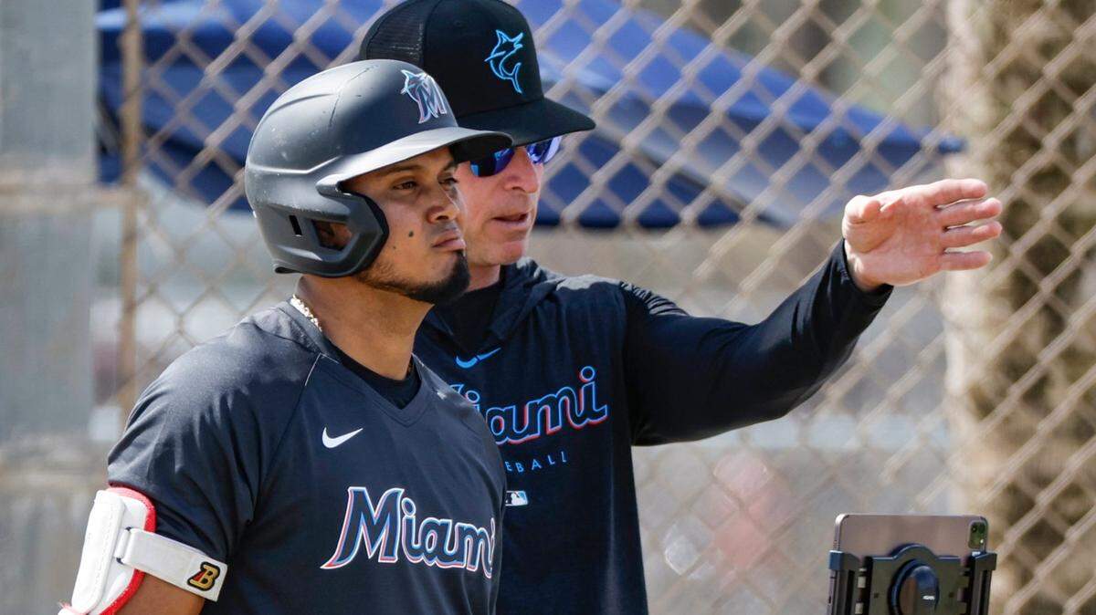 Miami Marlins infielder Luis Arraez listens to instructions from hitting coach Brant Brown at Roger Dean Chevrolet Stadium in Jupiter, Florida on Tuesday, February 21, 2023.