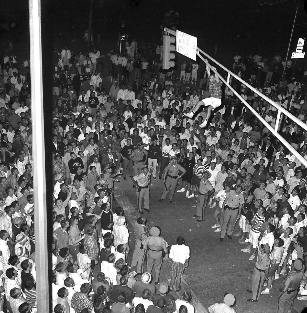 1961 spring break showing a student who climbed the light pole in front of the Elbo Room, from the Gene Hyde Collection Courtesy of The Fort Lauderdale Historical Society.
