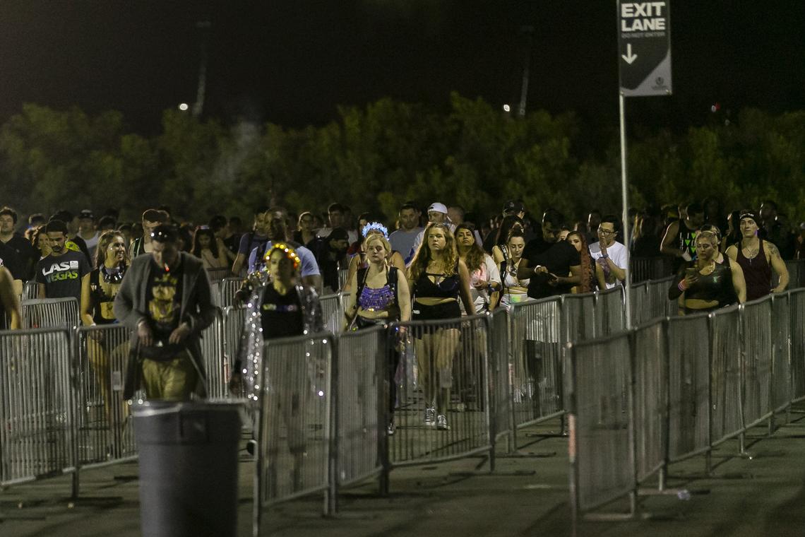 Festival goers make their way toward shuttle buses early Sunday morning after attending the second day of the 2019 Ultra Music Festival.
