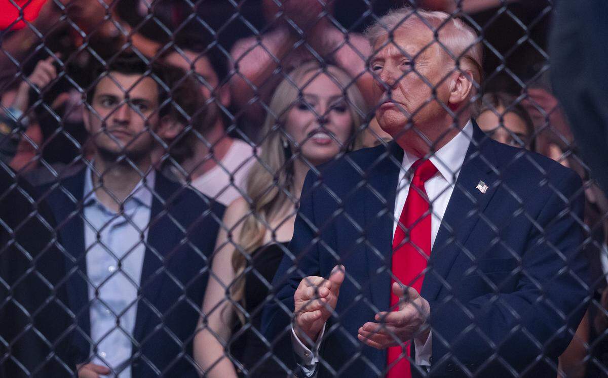 President Donald Trump applauds as Cub Swanson of the United States and Nate Landwehr of the United States fight in their featherweight bout at UFC 327 at the Kaseya Center on Saturday, April 11, 2026, in downtown Miami, Fla.