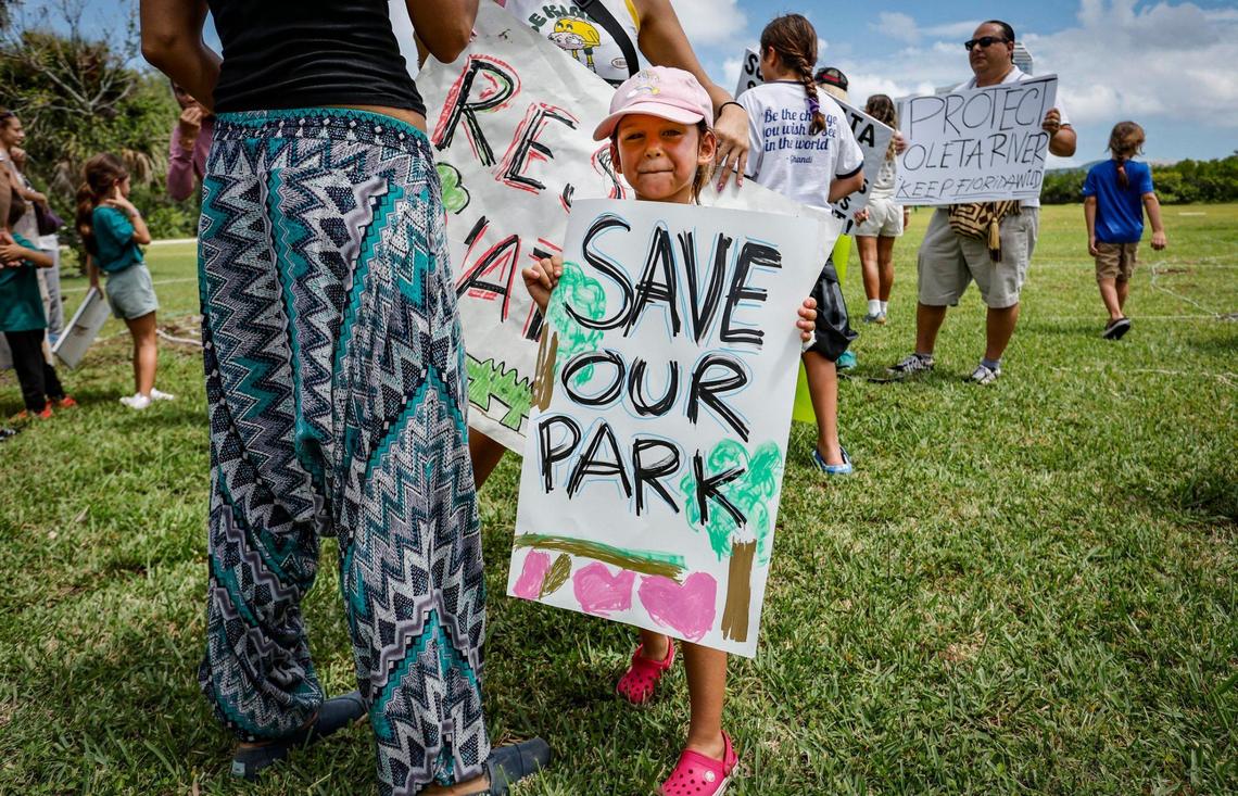 Mila Gatti, 5, joins protesters with Keep Florida State Parks Wild-Defend Oleta State Park against the Florida Department of Environmental Protection’s plan to add pickleball courts, cabins, and a disc golf course to Oleta River State Park in North Miami Beach, Florida on Tuesday, August 27, 2024.