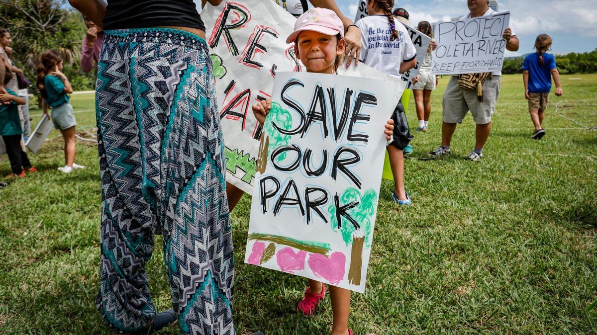 Mila Gatti, 5, joins protesters with Keep Florida State Parks Wild-Defend Oleta State Park against the Florida Department of Environmental Protection’s plan to add pickleball courts, cabins and a disc golf course to Oleta River State Park in North Miami Beach on Aug. 27, 2024.