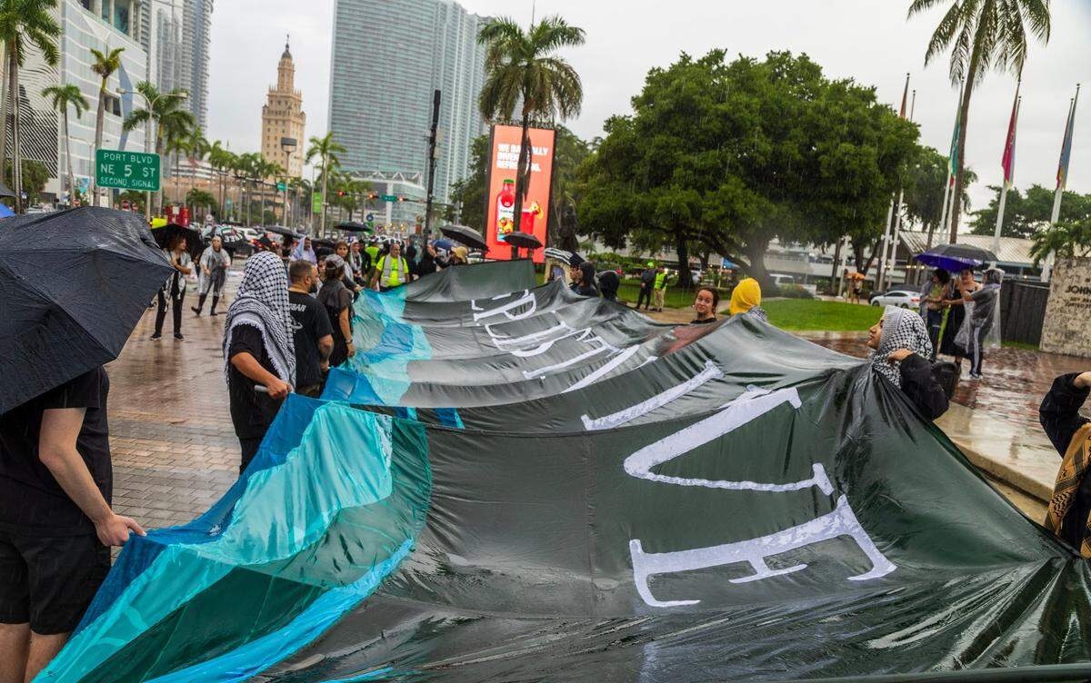 Demonstrators carry a large sign down Biscayne Boulevard that reads ‘Let Palestine Live’ protestors called for the Biden administration to stop sending weapons and funds to Israel.