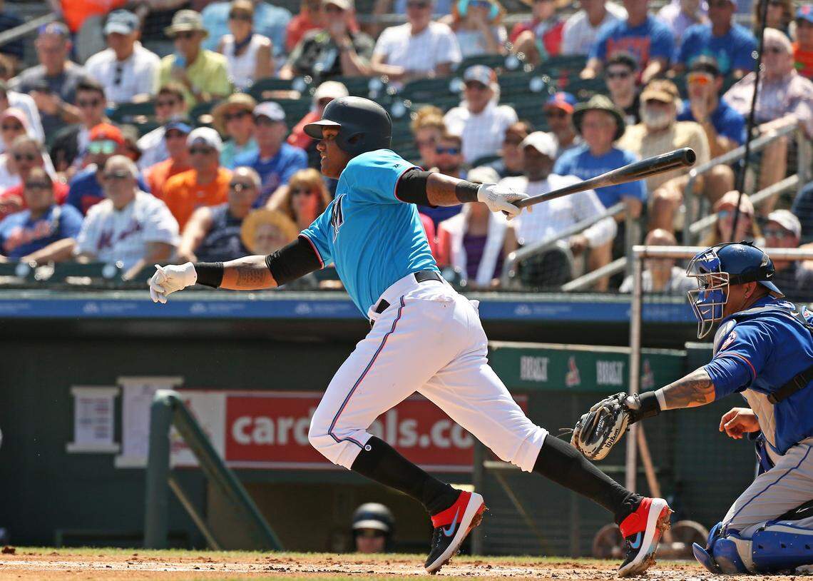 Miami Marlins second baseman Starlin Castro (13) hits a single during the first inning of a Major League Baseball spring training game against the New York Mets at the Roger Dean Chevrolet Stadium on Tuesday, March 12, 2019 in Jupiter, FL.