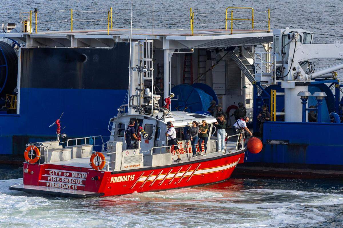 A City of Miami Fire-Rescue vessel motors next to a vessel to transport sex trafficking victims recovered by a rescue team during a South Florida Public Safety Regional Assets in Action Demonstration showcasing an active threat response incident in Biscayne Bay as part of the annual 2024 National Homeland Security Conference at PortMiami, Terminal J on Wednesday, July 24, 2024, in Miami, Fla.