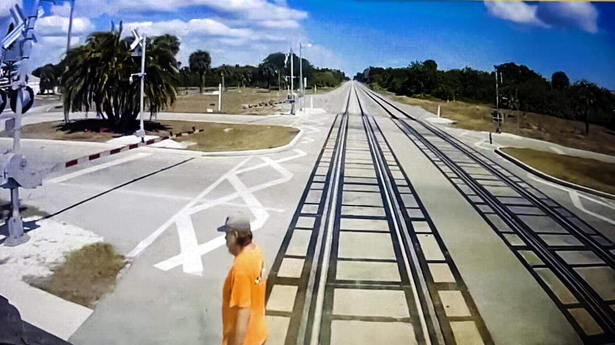 This still image taken from a Brightline train cam shows Randy Johanson, 62, shortly before the train struck him on April 18, 2024. He had made it across the tracks, but trains are wider than the rails by about three feet on each side.