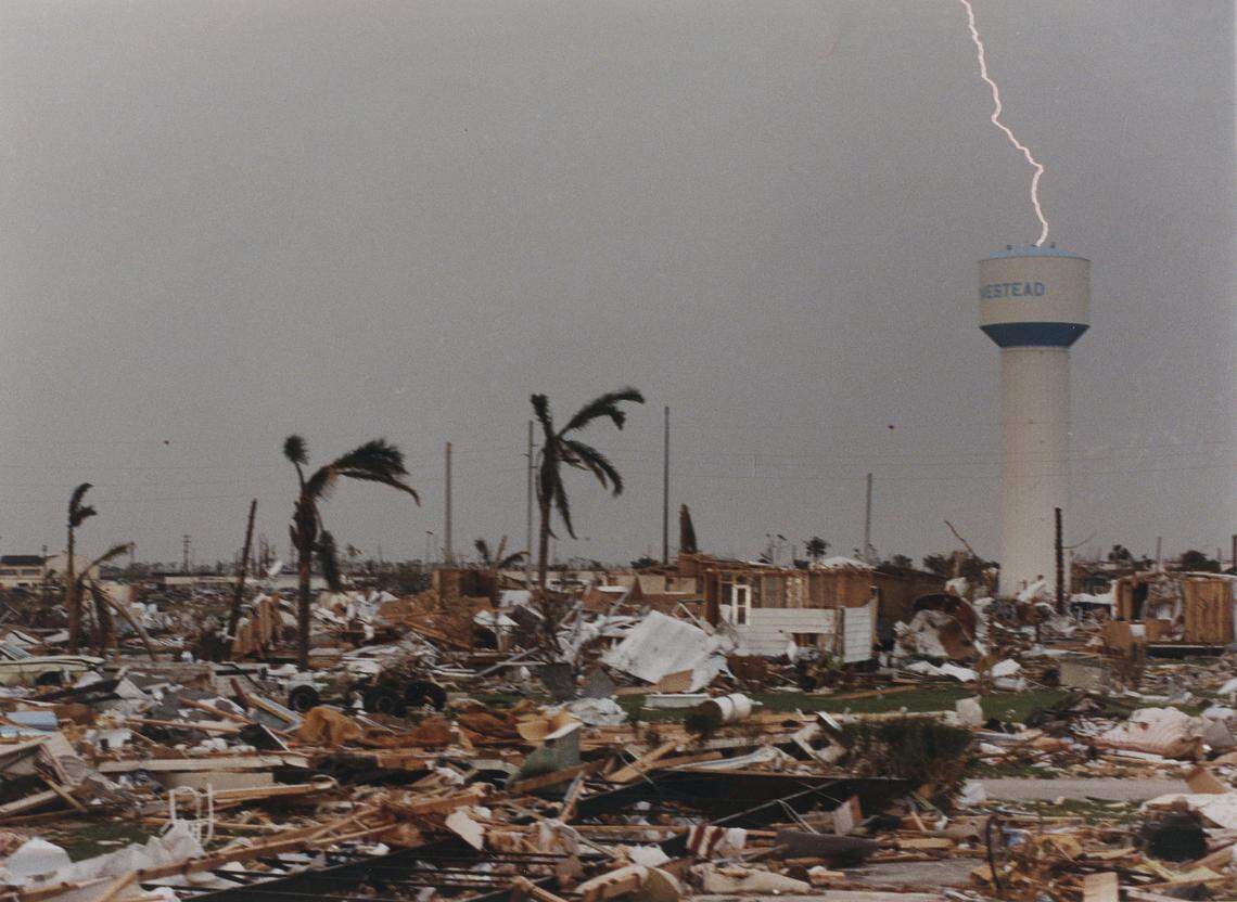 STRIKING TWICE: On the seventh day after the storm, thunderstorms sweep through South Miami-Dade, once again drenching furniture in exposed houses and leaving many people mired in mud. This stark scene, near the Homestead city hall, shows graphically the devastation the city suffered.