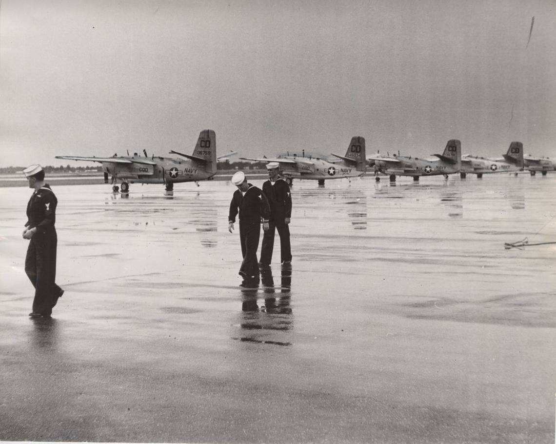 Published 10/24/1962: Carrier Enterprise crew stretches legs during a break at Palm Beach International Airport; brief stopover, then on to the Caribbean. The Navy landed six transport planes rushing crew members of the aircraft carrier Enterprise to their ship. The Navy planes, twin engine Gruman TFs, modified versions of anti-submarine patrol planes, refueled and left.