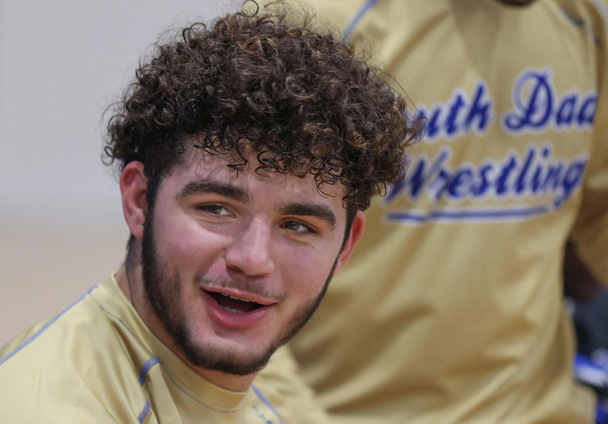 South Dade junior and wrestling standout Sawyer Bartelt, 17, talks to teammates as he waits to compete in the regional match at South Dade HS on Thursday, January 12, 2023.