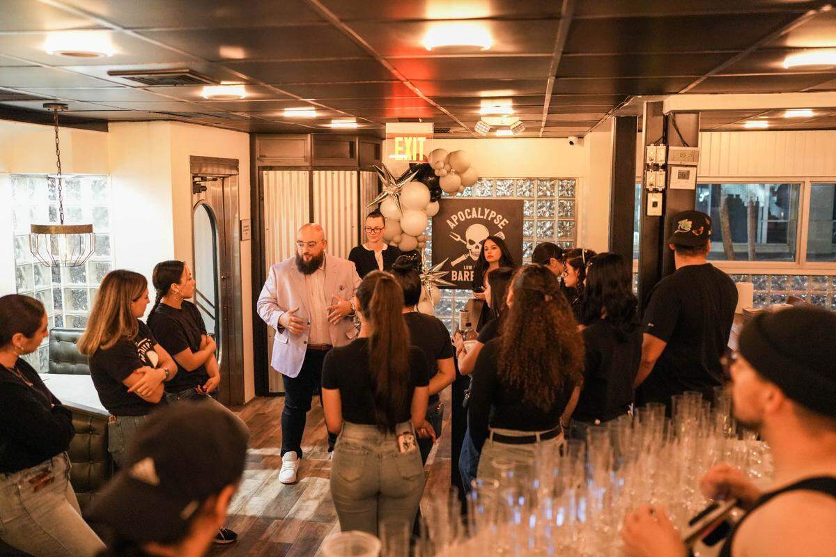 Owner Jeff Budnechky talks to staff members at the new Apocalypse BBQ in Kendall.