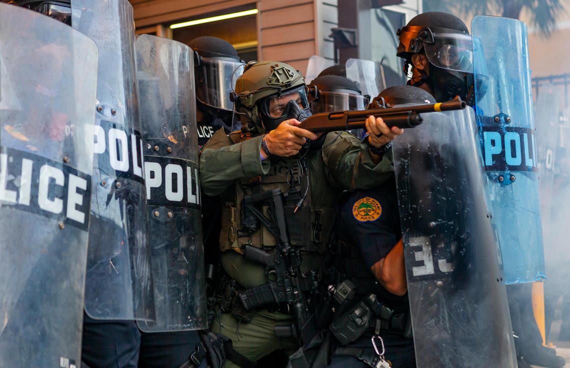 A police officer shoots rubber bullets toward activists during a ÒJustice for George FloydÓ protest in downtown Miami on Saturday, May 30, 2020.