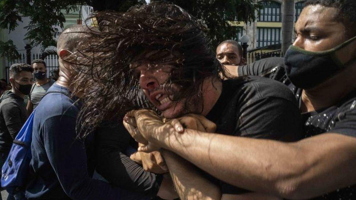Plainclothes police in Havana, Cuba, restrain a demonstrator during anti-government protests on July 11.
