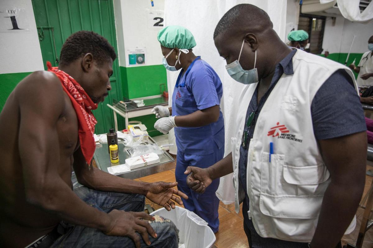 The cloud of dust in the air in front of the Médecins Sans Frontières/Doctors Without Borders hospital in Haiti’s capital is actually a good thing -- it shows that the gangs who normally rule over the area are not present, and so traffic is circulating. A MSF medical worker takes care of a patient in the emergency room at the Martissant Hospital, in Martissant, Haiti on May 31, 2021. -