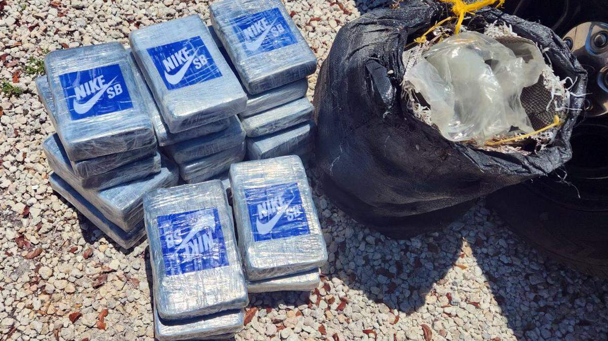 Packages of cocaine marked with a Nike logo are set on the ground of a Key Largo parking lot Wednesday, June 5, 2024. Scuba divers found the drugs floating in about 100 feet of water, according to the Monroe County Sheriff’s Office.