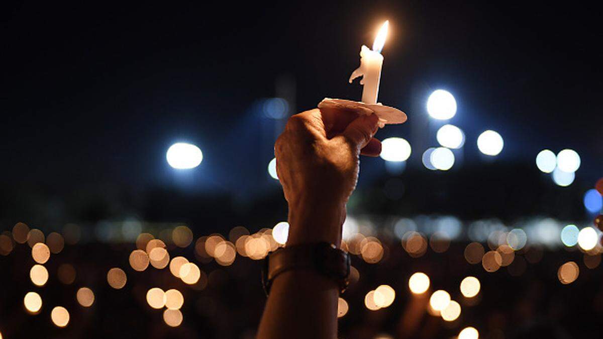 People gather for a candlelight vigil in honor of the victims of the Marjory Stoneman Douglas High School shooting in February 2018.