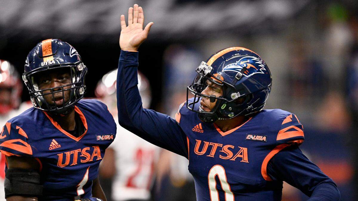 UTSA quarterback Frank Harris (0) congratulates teammate De’Corian Clark for his touchdown reception during the second half of an NCAA football game against Western Kentucky, Saturday, Oct. 8, 2022, in San Antonio. UTSA won 31-28. (AP Photo/Darren Abate)