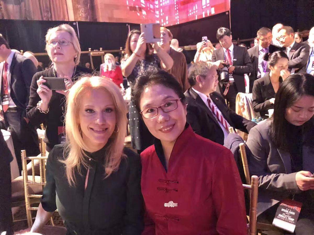 Trump adviser Kellyanne Conway poses with Xianqin Qu, president of the Florida Chapter of the Council for the Promotion of Peaceful Unification, at an RNC fundraiser on Dec. 2, 2017.