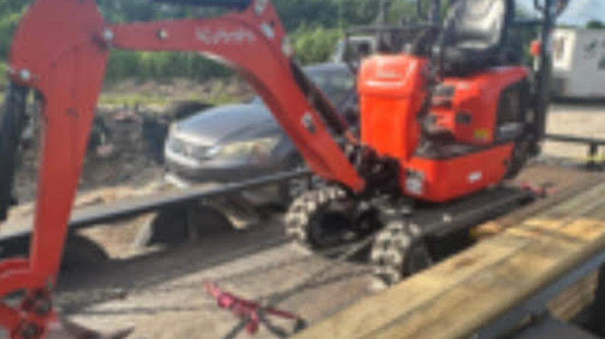 An excavator is parked on a flatbed trailer. The Broward Sheriff’s Office said the vehicle is one of 21 a Fort Lauderdale man and others fraudulently rented from several Home Depot stores and sold online.
