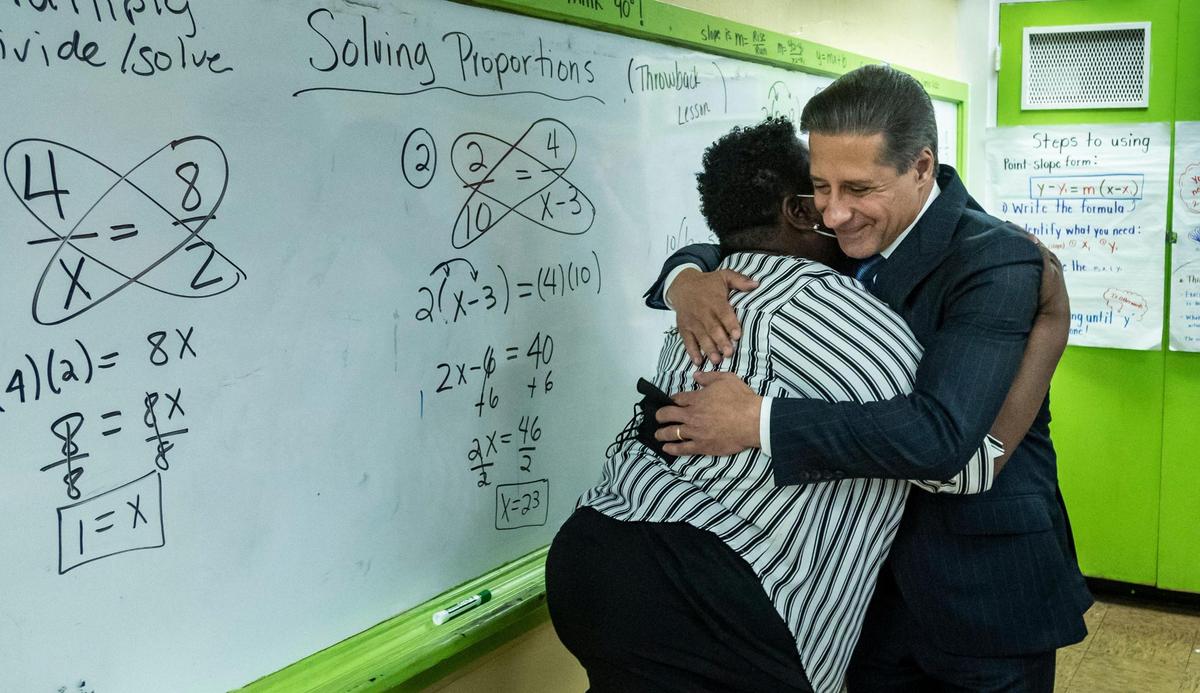 Alberto Carvalho hugs teacher Felicia Williams while visiting her classroom at Hialeah Senior High on Feb. 3, 2022.