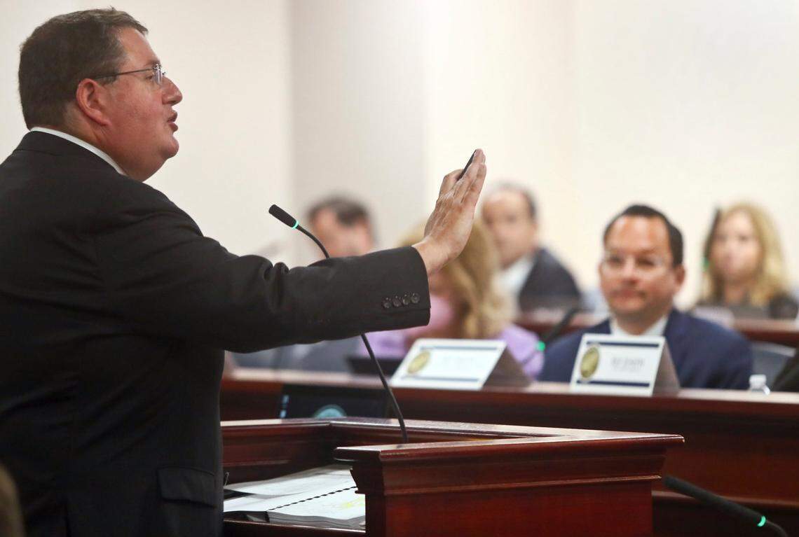 Rep. Randy Fine, R-Palm Bay, answers a question about the Independent Special Districts bill that would affect Disney during a State Affairs Committee meeting Tuesday, April 19, 2022, at the Capitol in Tallahassee, Fla. In back listening is Rep. Carlos Guillermo Smith, D-Orlando.