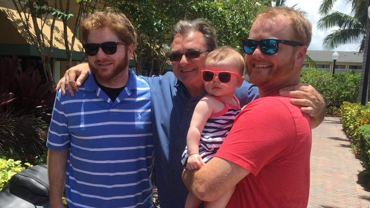 This Thanksgiving marks 50 years at the Miami Herald for sports columnist Greg Cote. Here, he is pictured with sons Michael (left) and Chris, who is holding Greg’s granddaughter.
