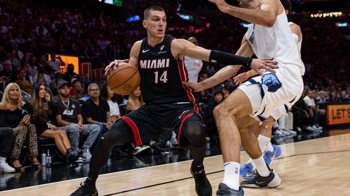 Miami Heat guard Tyler Herro (14) looks to pass while defended by Memphis Grizzlies forward Santi Aldama (7) during the second half of an NBA game at Kaseya Center on April 3, 2025, in Miami.