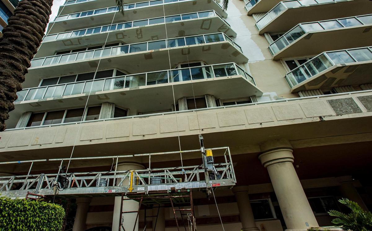 Construction scaffolds hang outside the Collins Avenue facade of the Mirage condo tower on Oct. 2, 2021.
