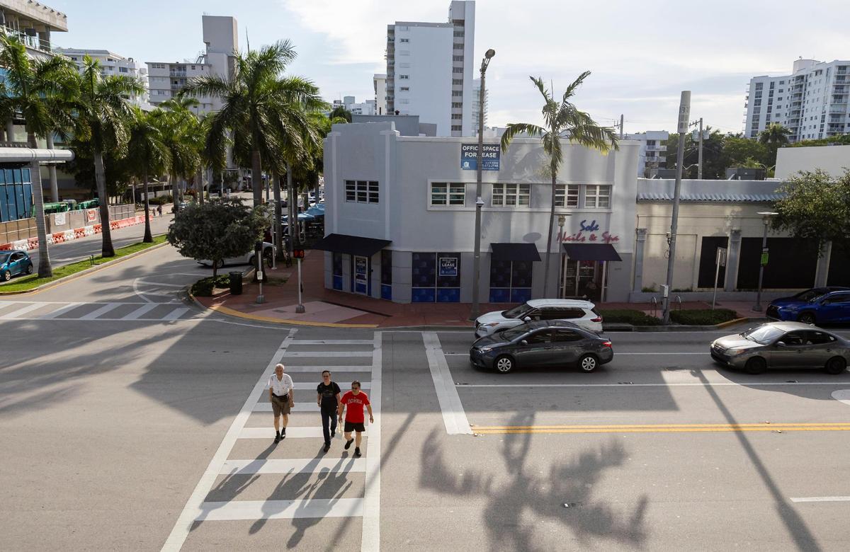 An aerial photo shows the Alton Road site once partially occupied by Miami Beach’s famed Epicure Market, which was open from 1945 until it closed because of damage from Hurricane Irma in 2017. The building will be replaced by a six-story luxury office building. In this photo, people walk across Alton Road near the future sight of new office building on June 21, 2023.