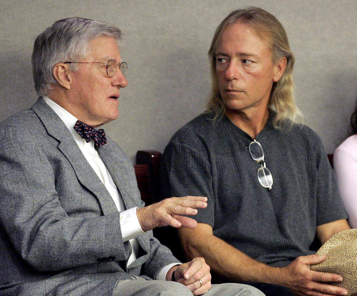 Wilton Dedge, right, listens to Sandy D’ Alemberte, left, a member of his legal team, during House session, Thursday, Dec. 8, 2005, in Tallahassee, Fla. The legislature is expected to pass a bill compensating Dedge for time spent in prison as a result of a wrongful conviction over 20 years ago.(AP Photo/Phil Coale)