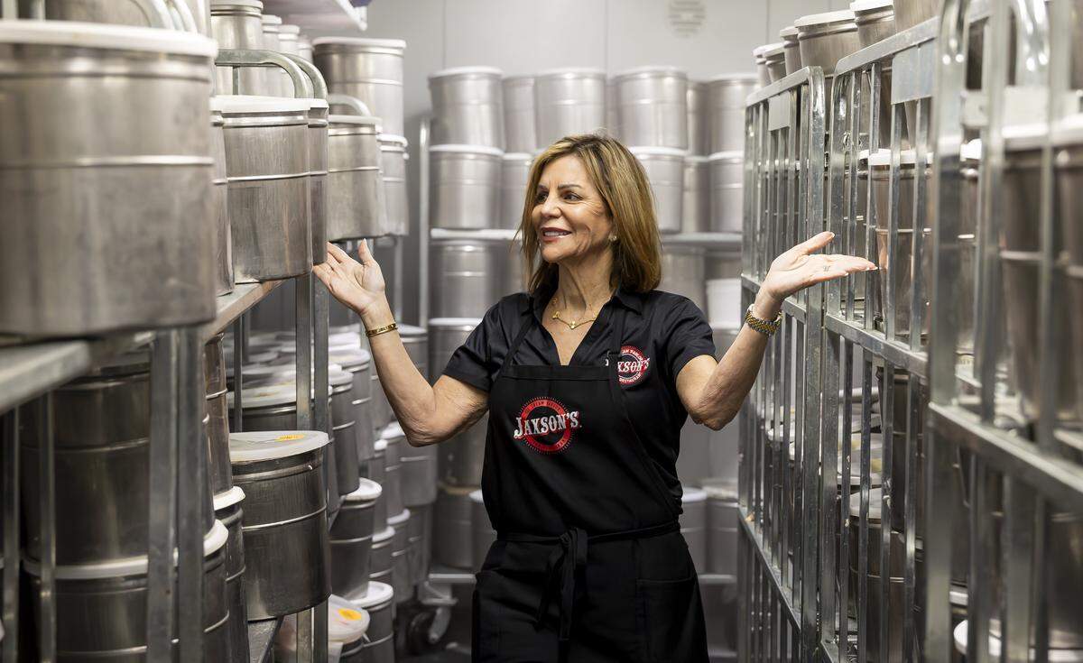 Linda Udell Zakheim, the owner of Jaxson's Ice Cream Parlor & Restaurant, walks past metal tubs storing her homemade ice cream on Thursday, Feb. 5, 2026, in Dania Beach, Fla. Jaxson's is celebrating its 70th anniversary this month.