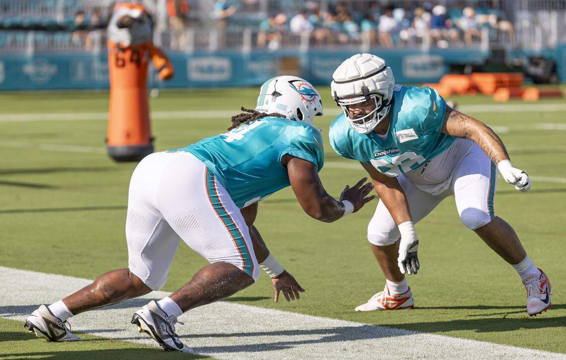 Miami Dolphins defensive tackles Jordan Phillips (94) and Alex Huntley (96) runs drills during training camp at the Baptist Health Training Complex on Tuesday, July 29, 2025, in Miami Gardens, Fla.