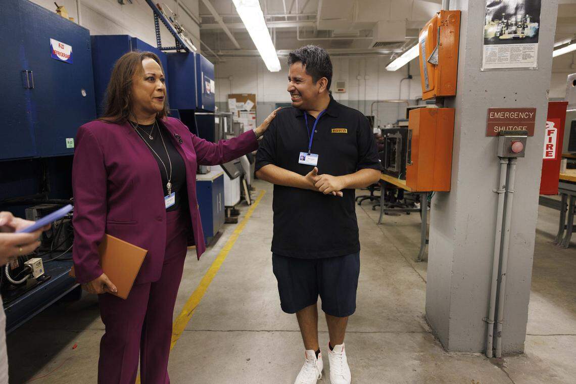 Chantal Osborne, director of Lindsey Hopkins Technical College, gives a compliment to Gerald Flores, instructor in HVAC with the Electricity program and former student, during the day on Tuesday, Oct. 21, 2025, at Lindsey Hopkins Technical College in downtown Miami. 