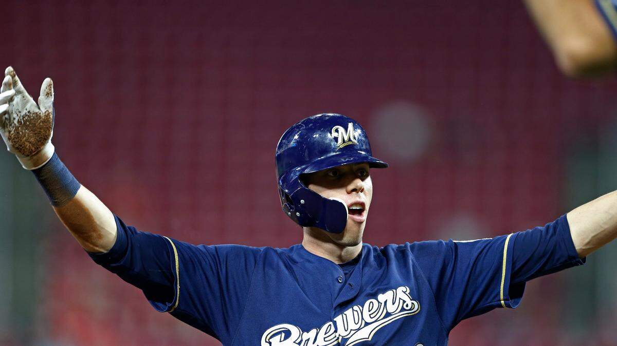 Milwaukee Brewers’ Christian Yelich reacts to hitting a triple off Cincinnati Reds relief pitcher David Hernandez during the seventh inning of a baseball game Wednesday, Aug. 29, 2018, in Cincinnati. Yelich hit for the cycle as the Brewers won 13-12 in 10 innings.