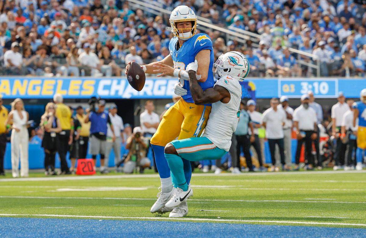 Miami Dolphins cornerback Kader Kohou (4) sacks Los Angeles Chargers quarterback Justin Herbert (10) near the goal line in the second half at SoFi Stadium in Inglewood, California on Sunday, September 10, 2023.
