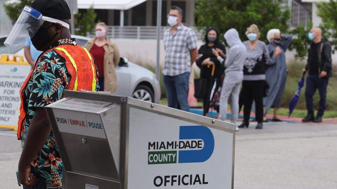 A long line of voters formed outside Miami Beach’s North Shore Library while a mail-in ballot drop box offered a short wait as Florida began its first day of early voting on Monday, Oct. 19, 2020.