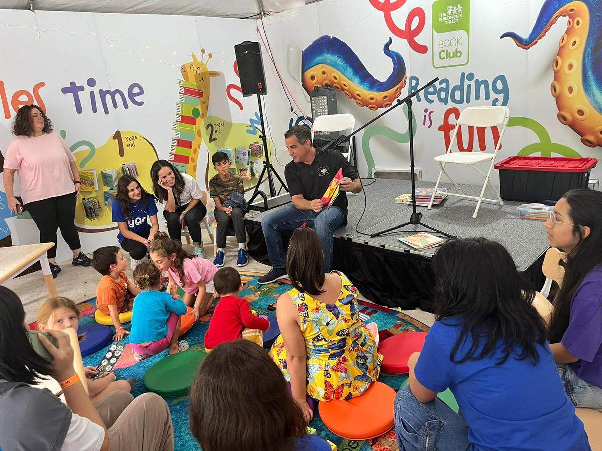 James Haj, president and CEO of the Children’s Trust reads to children during a Book Club Event at last year’s Miami Book Fair. Provided to the Miami Herald.